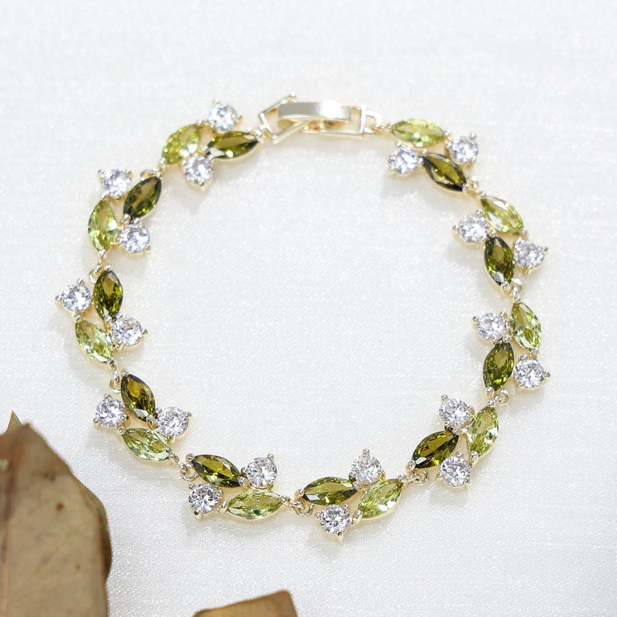 Emerald Whisper Leaf Bracelet – Green & White Zirconia Elegance in Gold Plated Copper